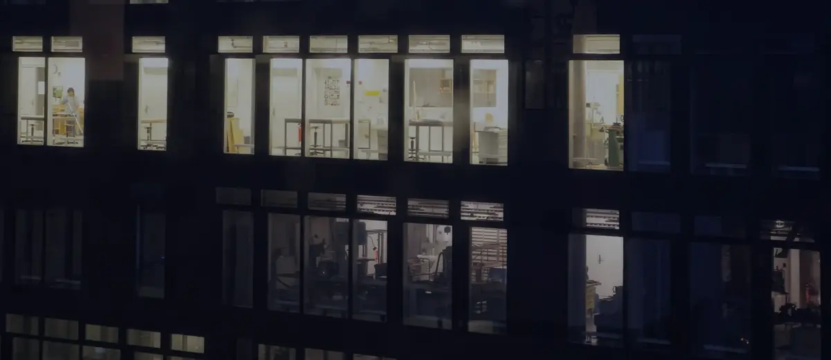 An office building with lit windows at night.
