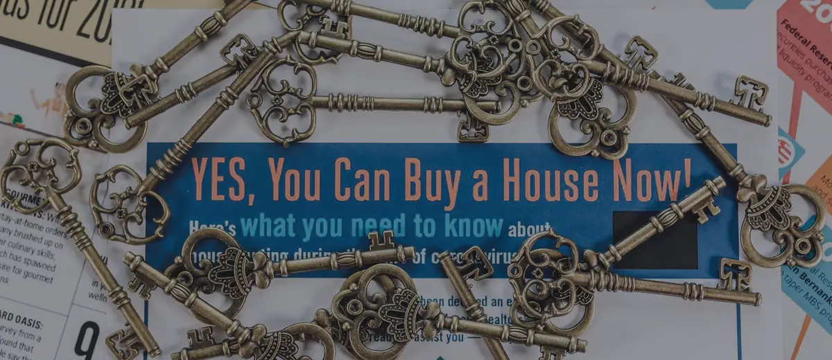 Vintage keys scattered across home-buying flyers.