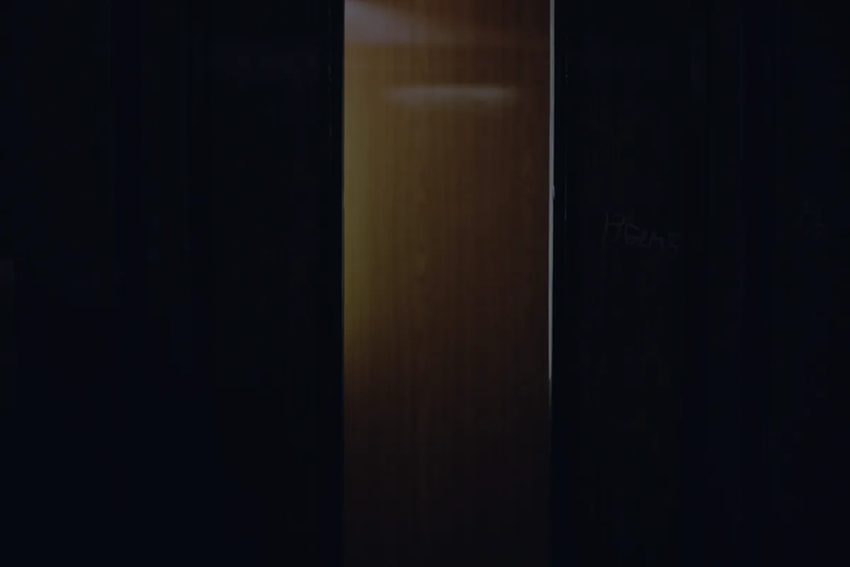 A warmly lit doorway in a dark interior, representing the backdoor Roth IRA strategy.