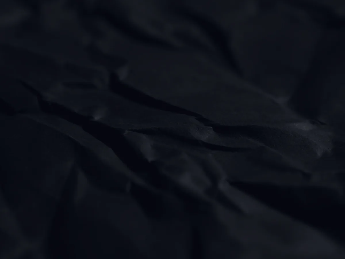 A dark torn-paper texture, representing a charged-off debt.