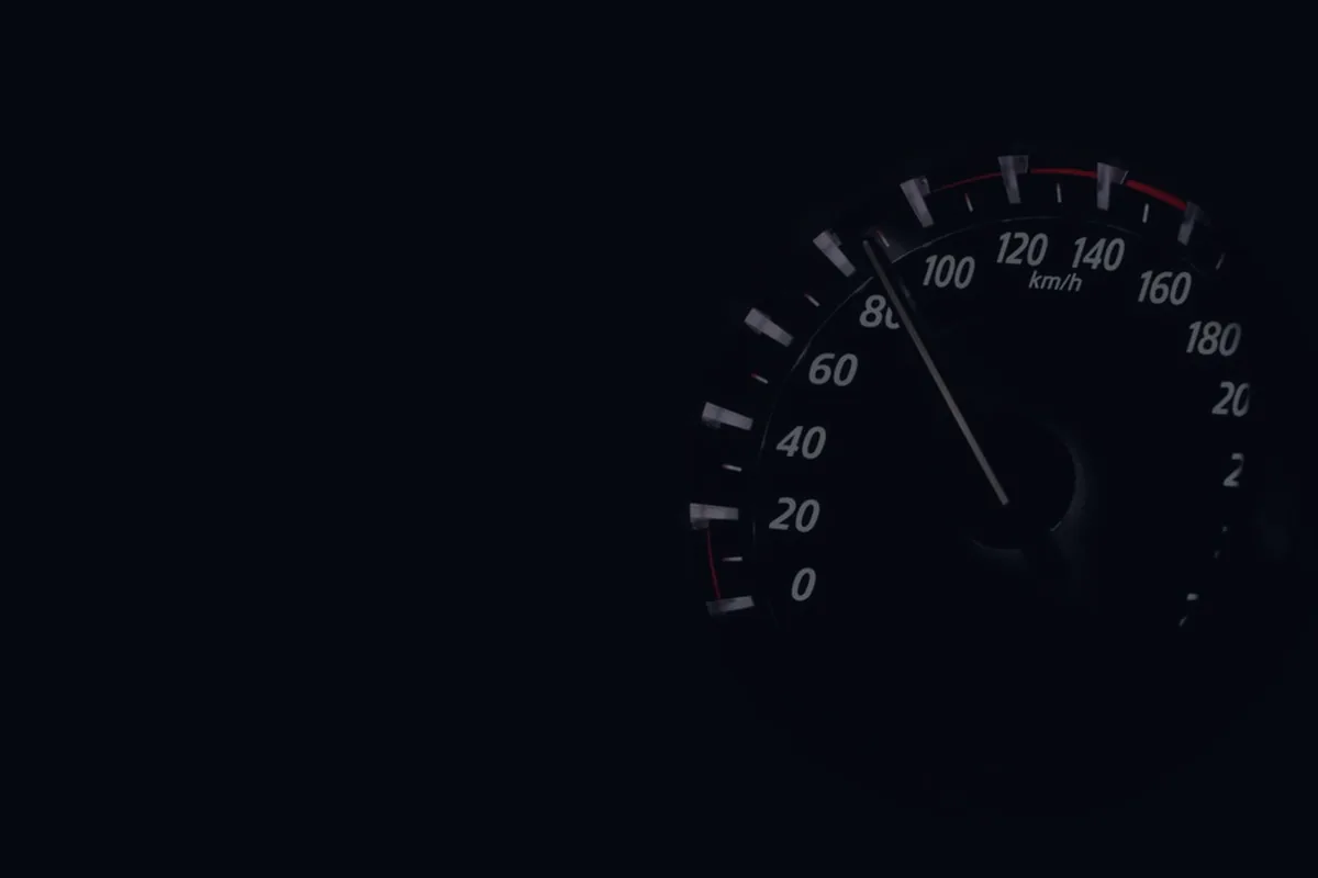 A dark gauge dial, representing credit score myths and how scores really work.