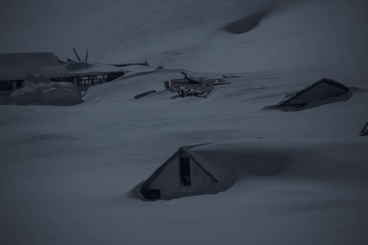 A dark snow-covered mountain peak, representing the debt avalanche versus snowball methods.