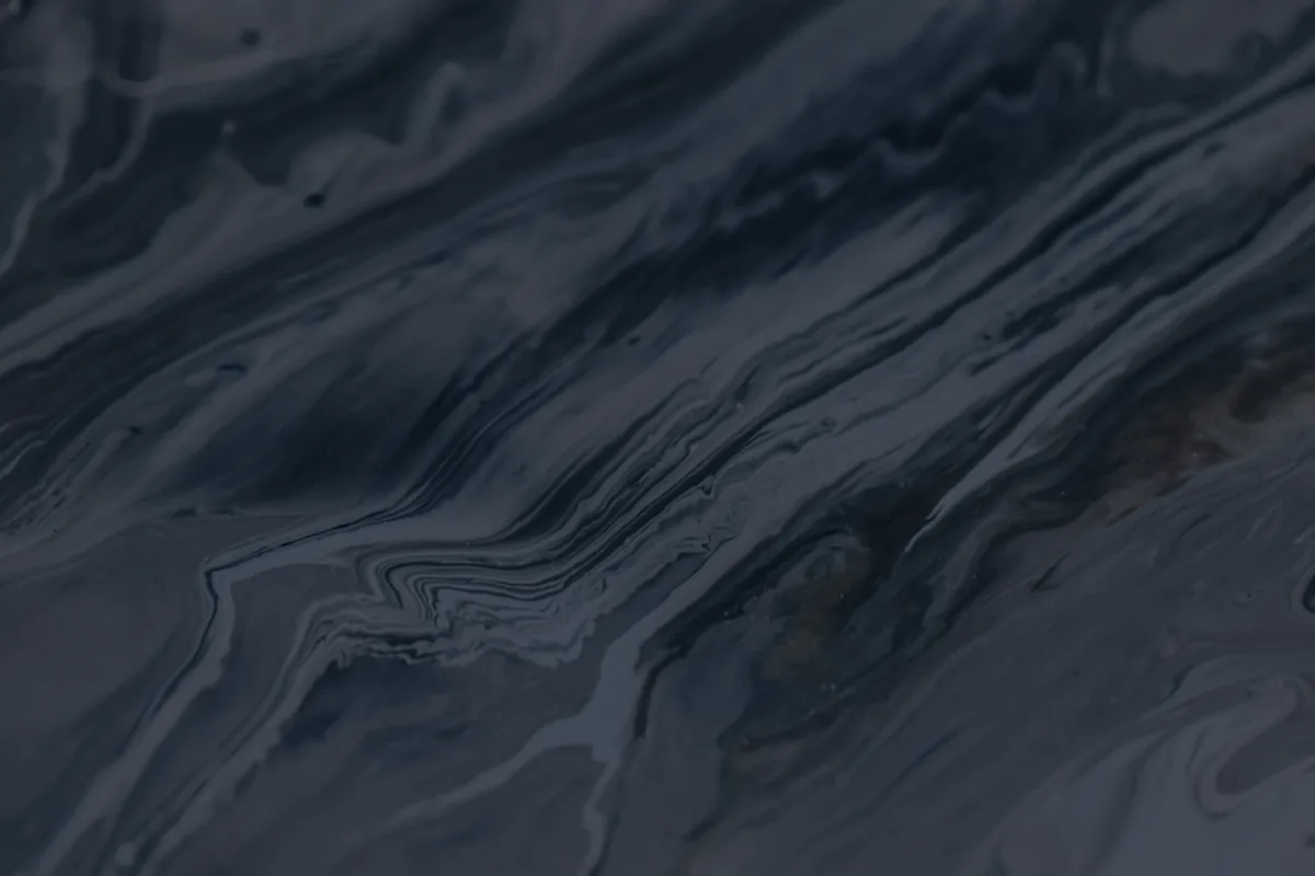 A dark marbled flowing texture, representing merging debts through consolidation.