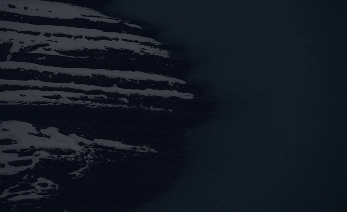 An abstract rolling form on a dark surface, representing the debt snowball method.