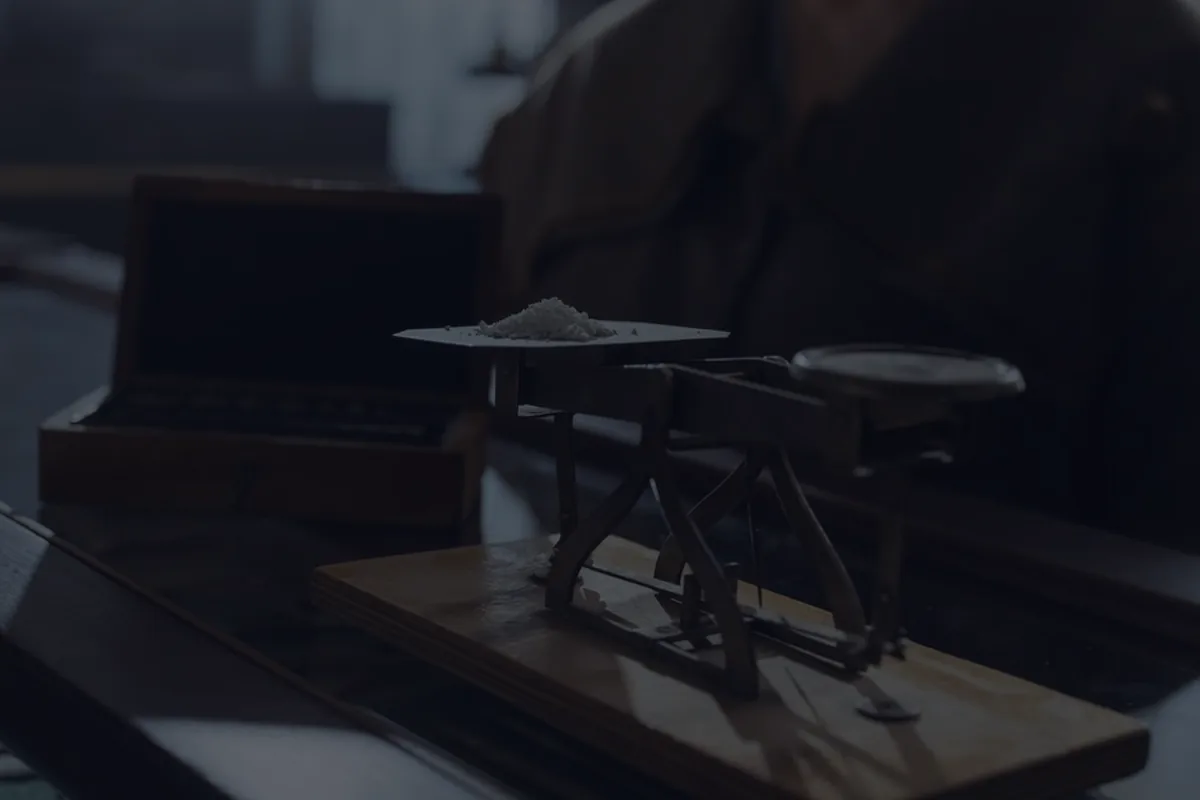 A balance scale in dramatic dark light, representing the debt-to-income ratio.
