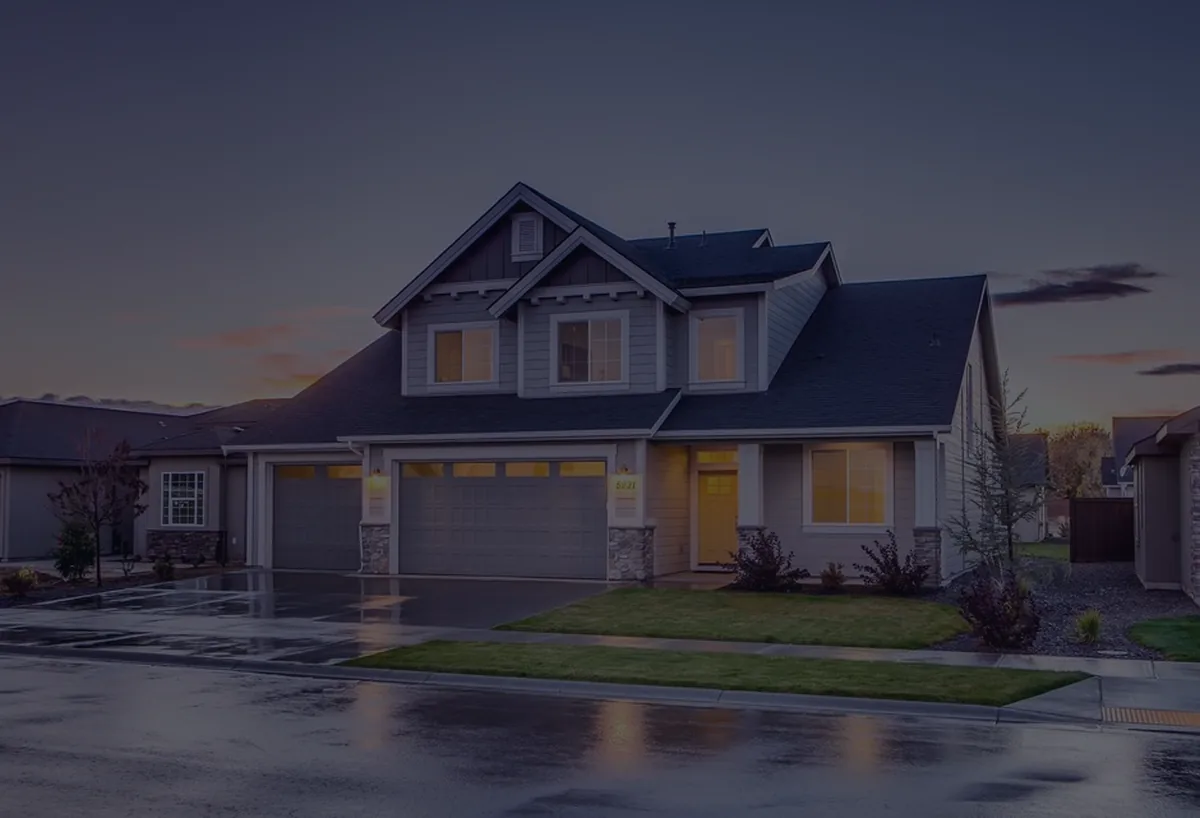 A warmly lit house at dusk, representing FHA versus conventional loans.