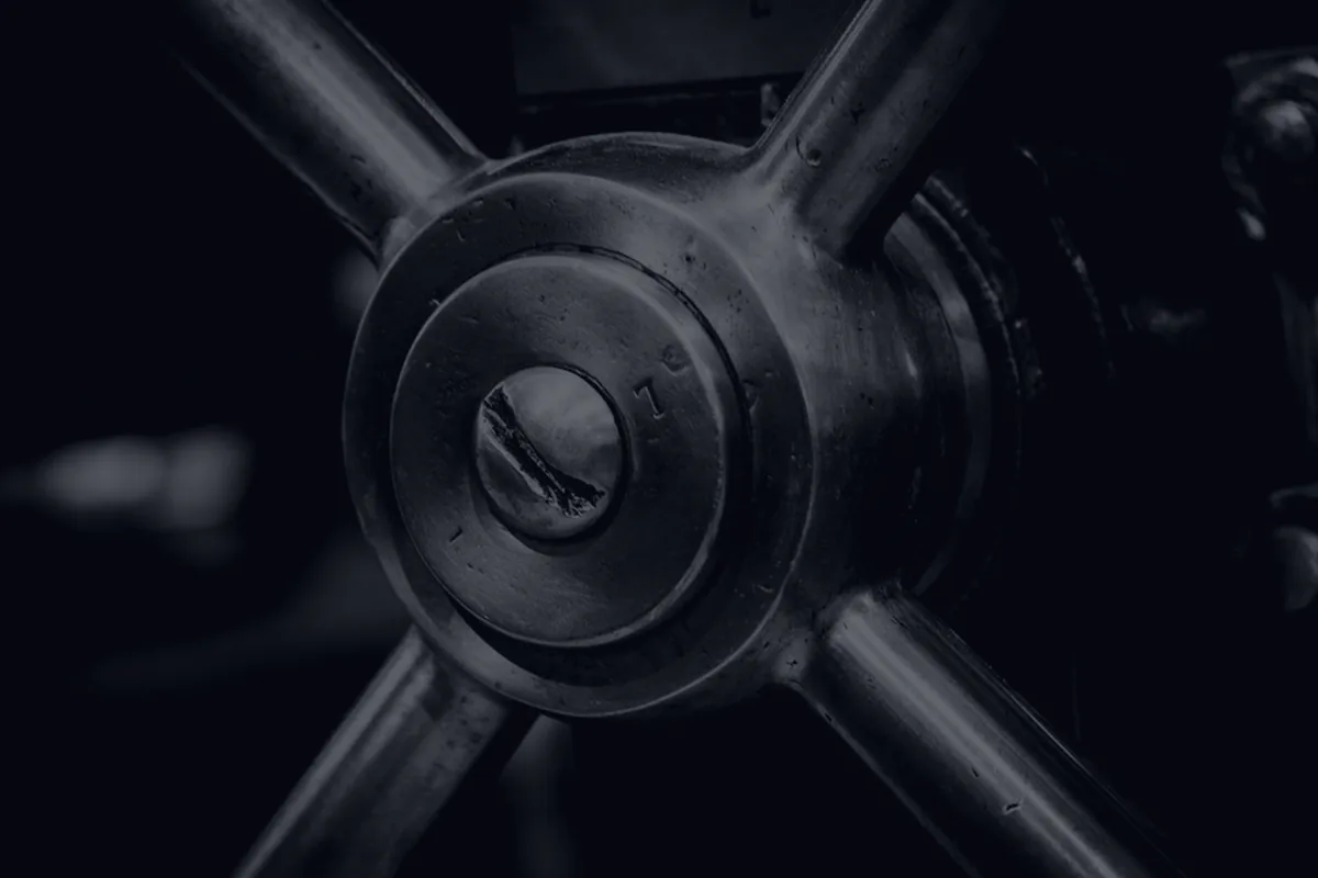 Dark interlocking metal gears, representing automating your finances.