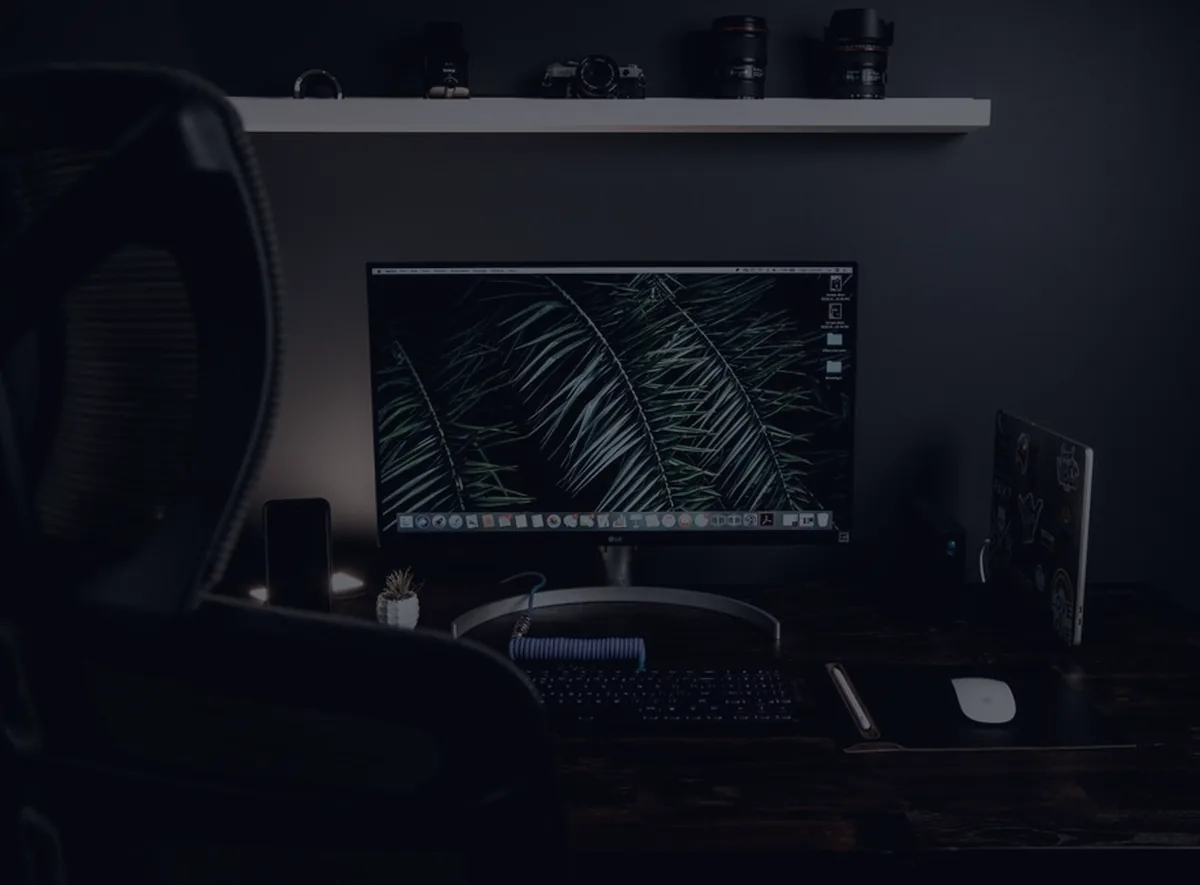 A dark home office workspace, representing a freelancer's tax setup.