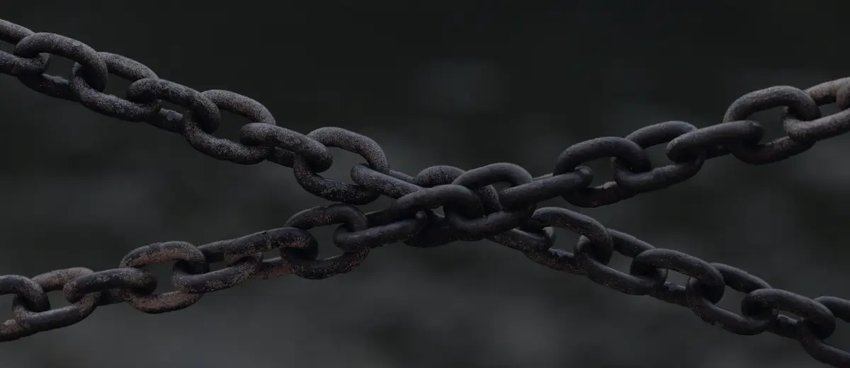 Two rusty chains crossed against a dark background.