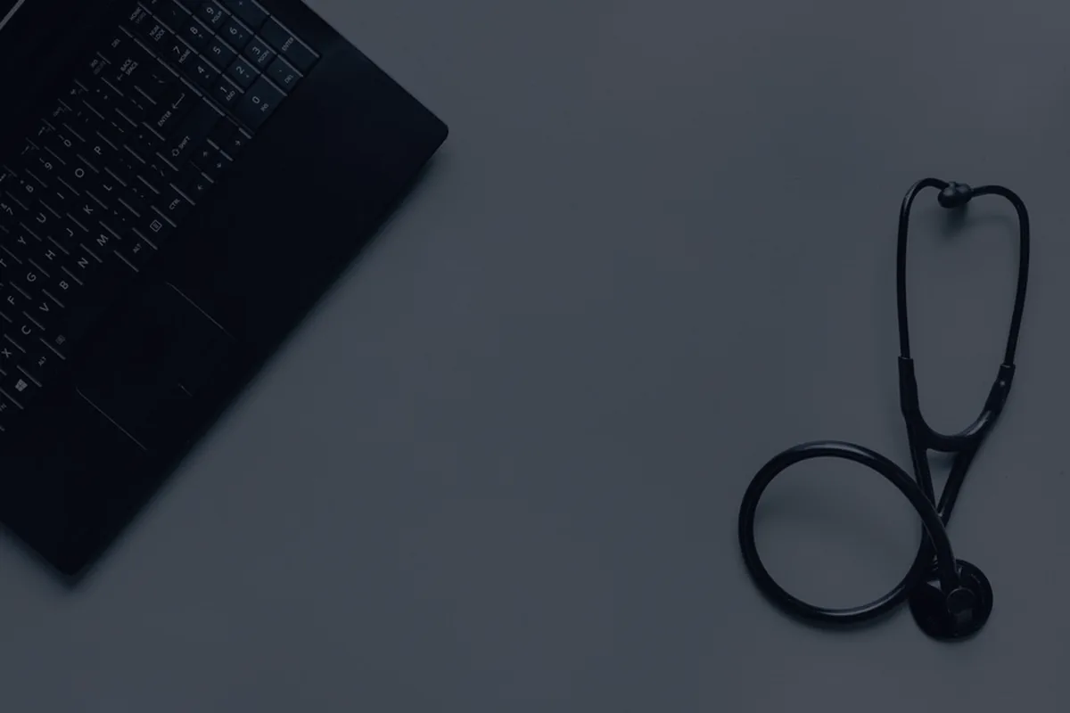 A stethoscope on a dark minimal surface, representing health insurance basics.