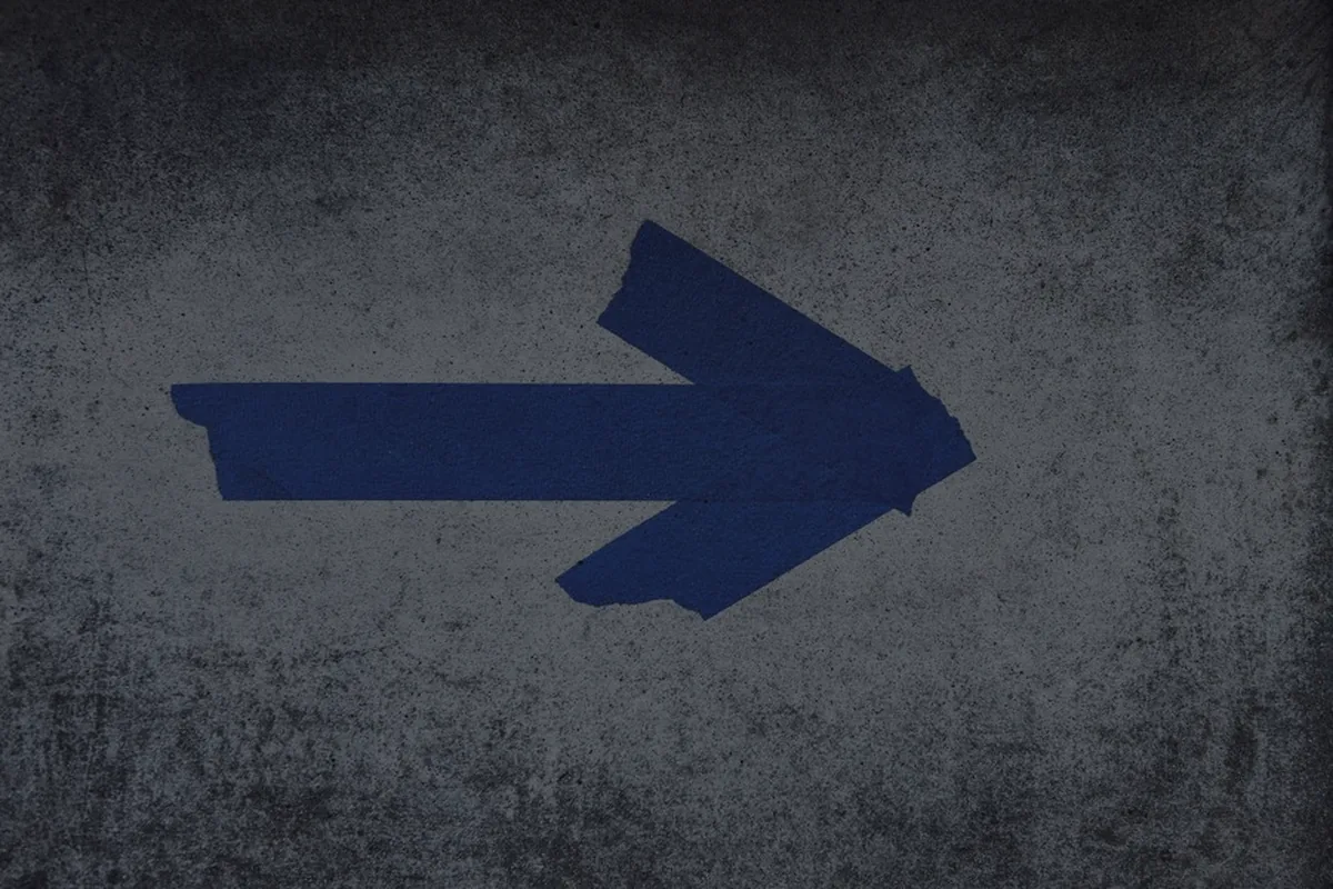 A blue arrow on a dark surface, representing how tax refunds work.