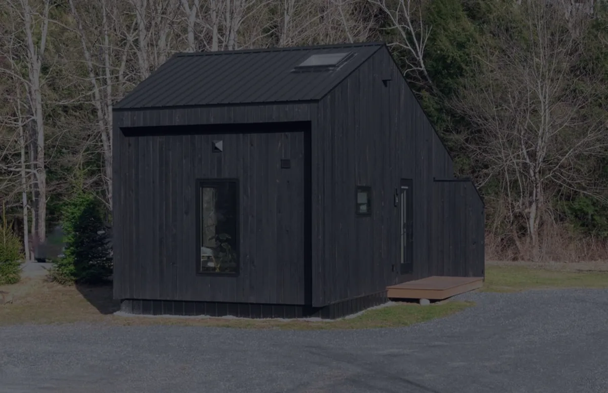 A small dark model house, representing buying a home with little money down.