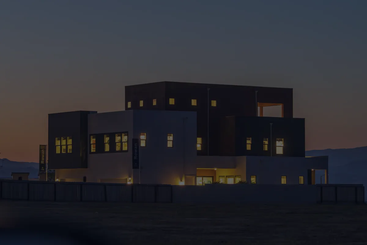 A modern building lit at dusk, representing refinancing a mortgage.