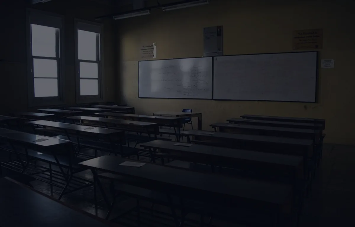An empty office with chairs in moody dark light, representing a job-loss checklist.