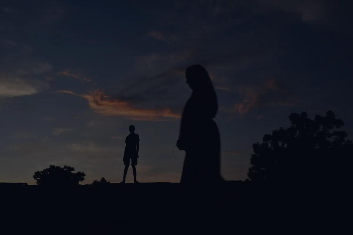 A family silhouette at dusk, representing types of life insurance.