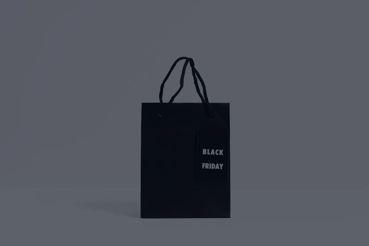 A single dark shopping bag, representing lifestyle creep.