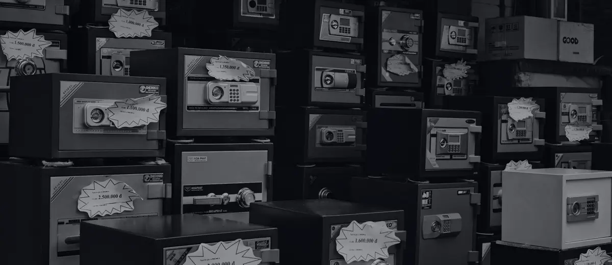 Rows of old metal safes in black and white.