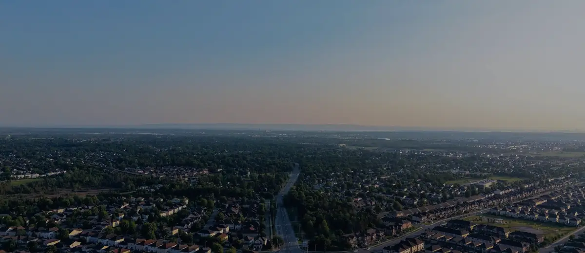 An aerial view of a suburban neighborhood at dusk.