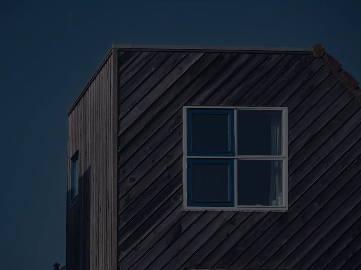 A dark modern house exterior, representing how mortgage rates work.