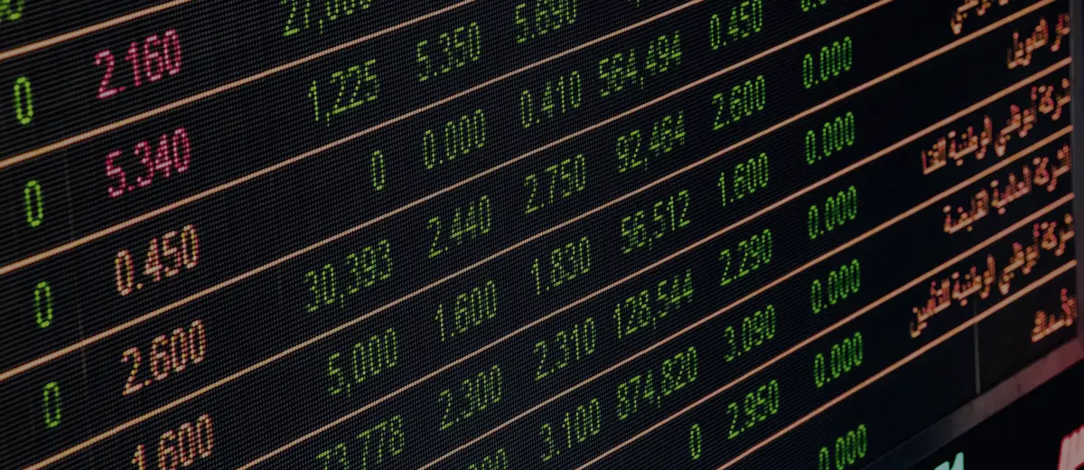A stock quote board with red and green numbers.