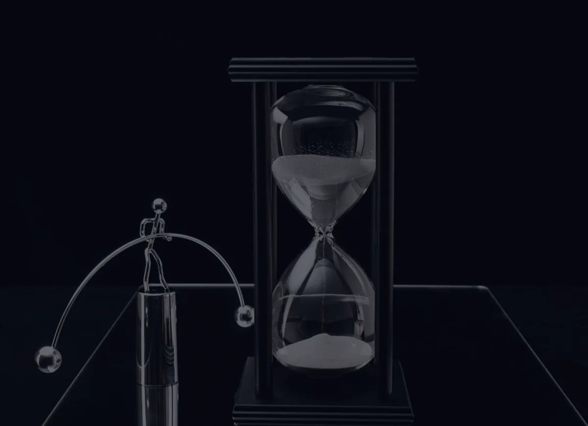 An hourglass on a dark surface, representing required minimum distribution timing in retirement.