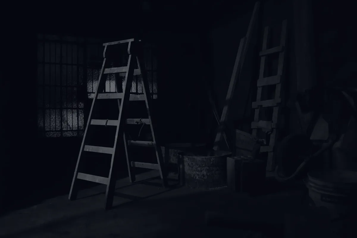 Ladders against a dark wall in dramatic light, representing a Roth conversion ladder.