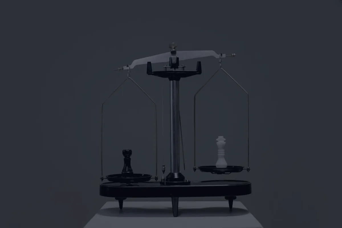 A balance scale on a dark background, representing the choice between a Roth IRA and a 401(k).