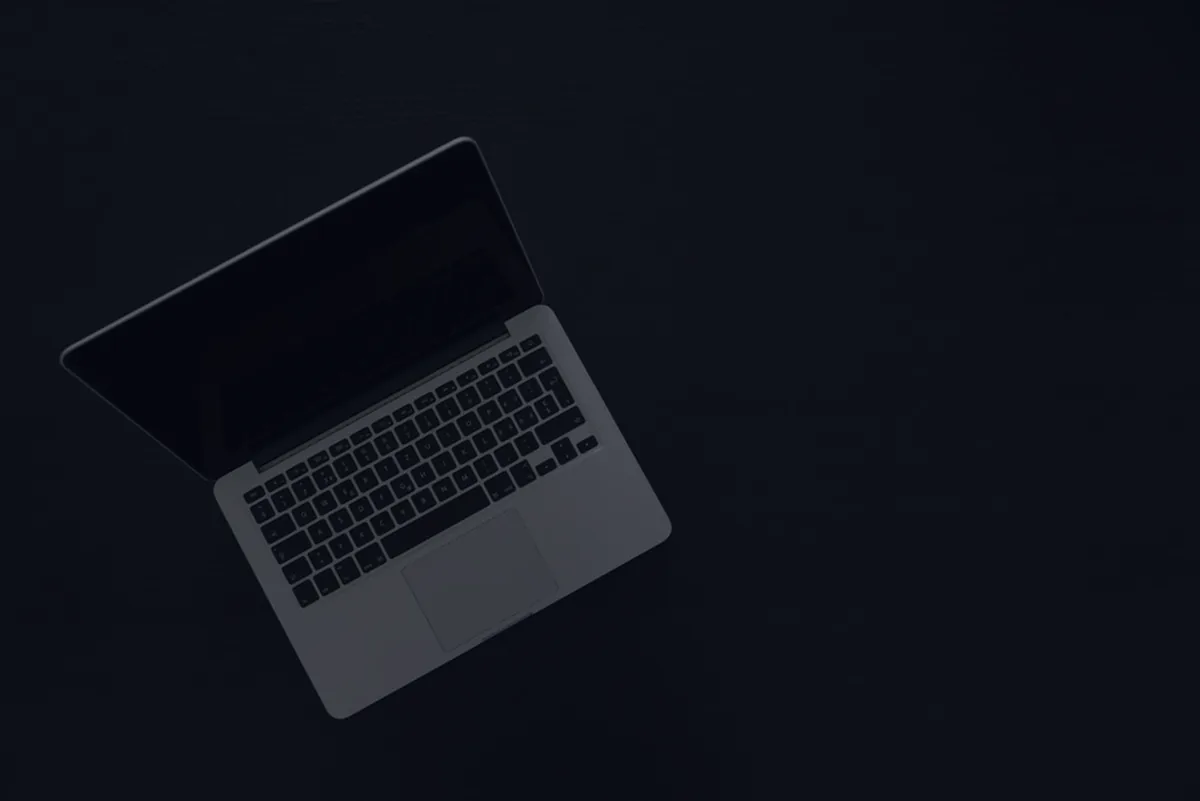 A laptop on a dark surface, representing self-employed taxes.