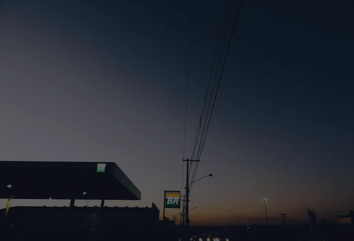 A for-sale sign at dusk in dark tones, representing a home-selling checklist.