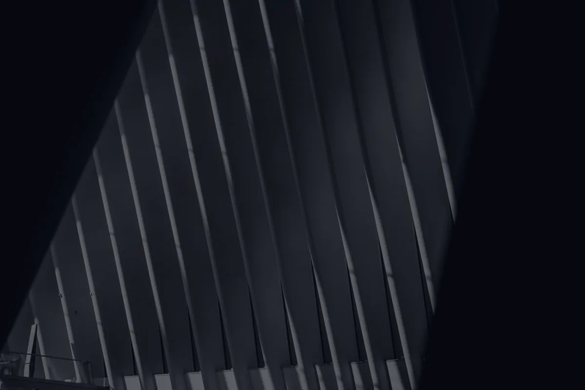 Three dark abstract architectural columns, representing the simple three-fund portfolio.