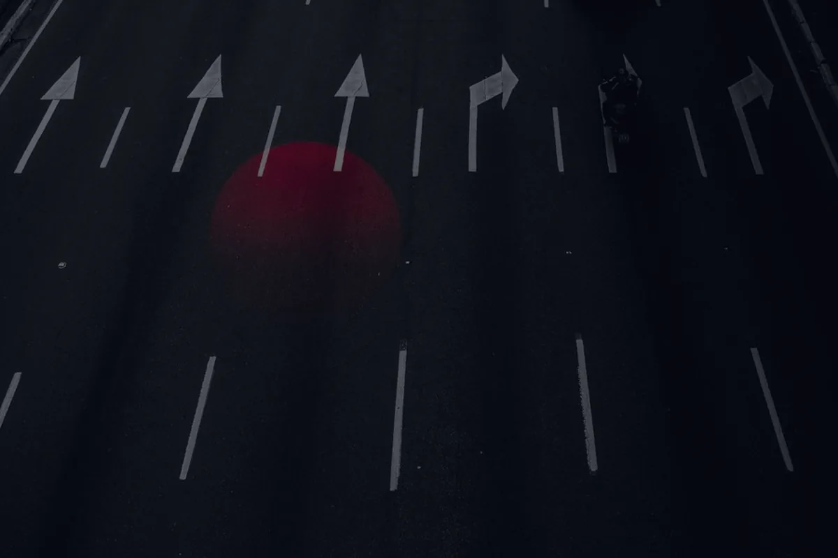Arrows on a dark road, representing a financial checklist for turning 65.