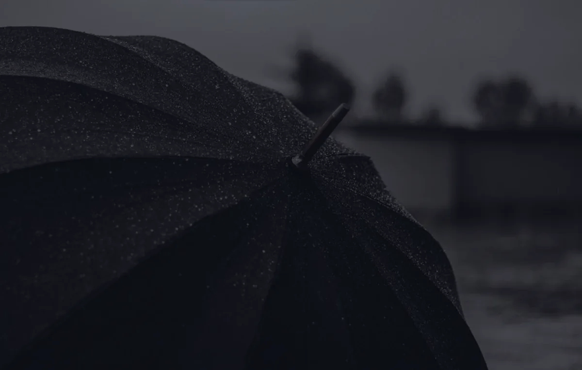 A single dark umbrella, representing umbrella insurance coverage.